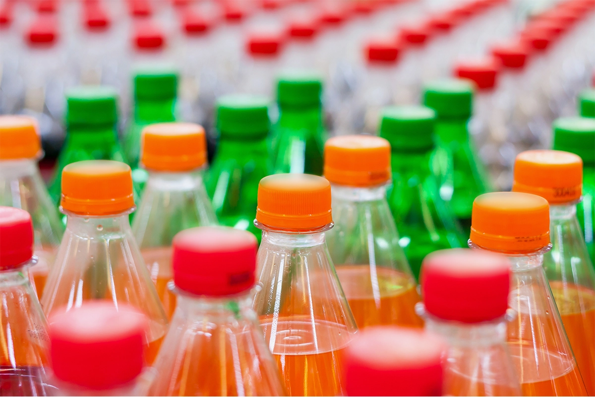 Plastic bottles of assorted carbonated soft drinks.
